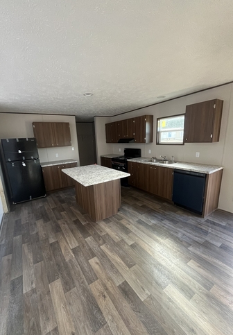 Kitchen area with black energy star appliances. 