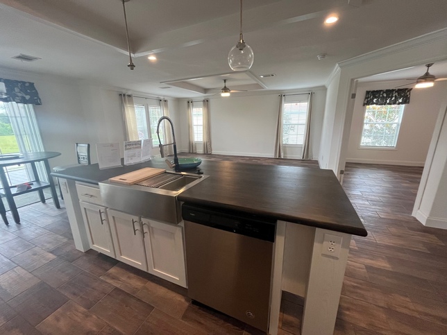 Island with Farmhouse Sink and Tray Ceilings
Living Room in Background