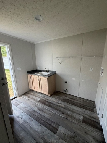 Laundry room with sink and coat closet