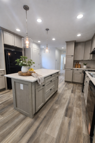 This Gourmet Eat-In Kitchen is EVERYTHING if you love to cook! Plenty of counter space, trash drawer & tilt-outs, loads of cabinets, LED lights, full ceramic tile backsplash, and a custom refrigerator surround! - A Better Way To Build