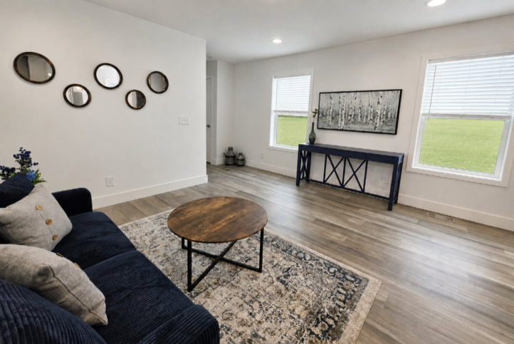 The open-concept kitchen flows seamlessly into this comfortable living room, creating the kind of great room that feels welcoming, comfortable, and made for everyday living.

#ABetterWayToBuild