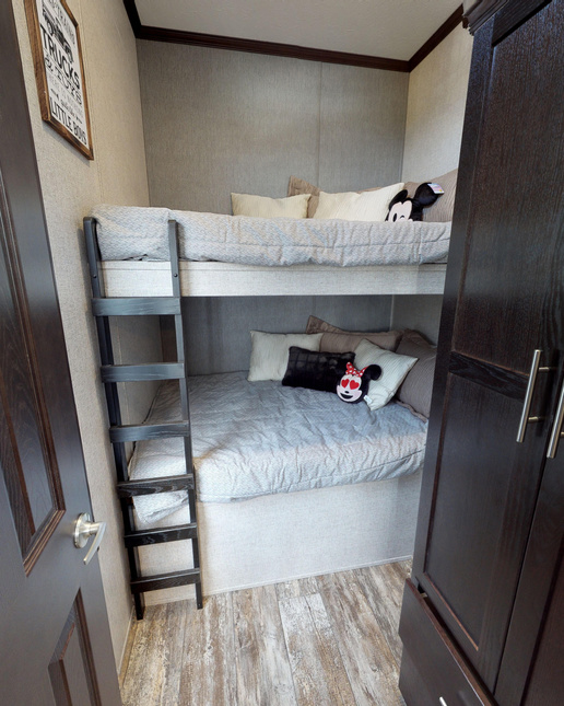 A perfectly comfy room for two in the Park Model 190002 by Fairmont Homes.