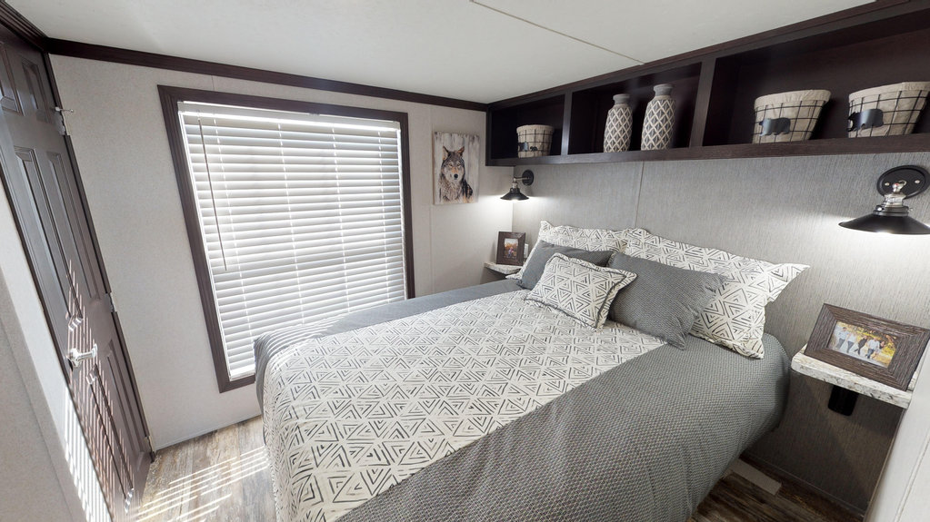 Attractive, comfortable and efficient bedroom in Fairmont Homes' model 190006 park model home.