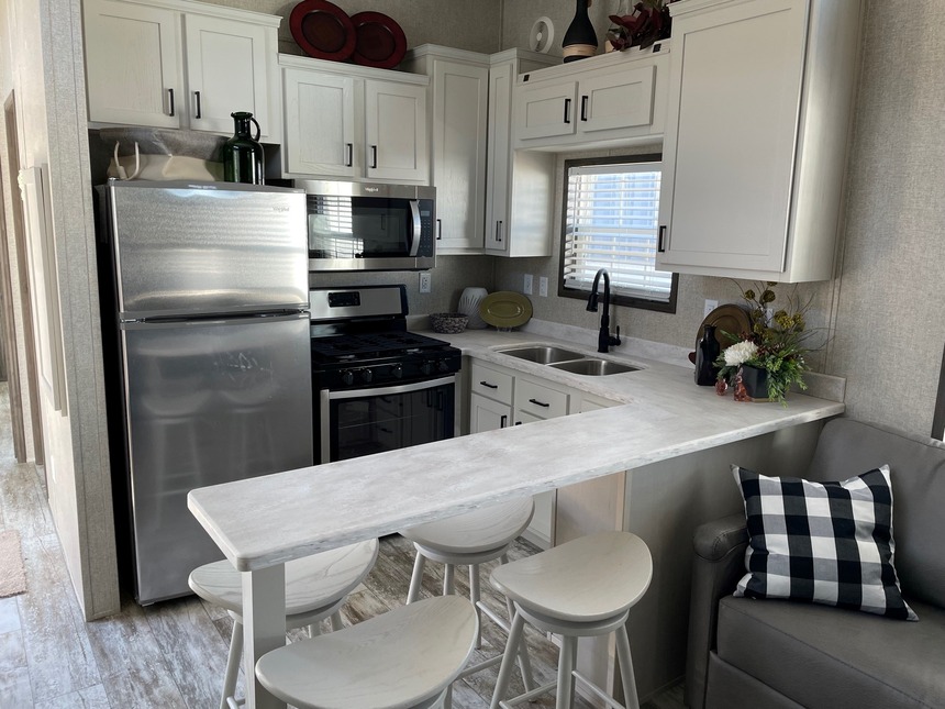 Beautiful and bright kitchen in a Cavco 150 190012 Park Model by Fairmont Homes.