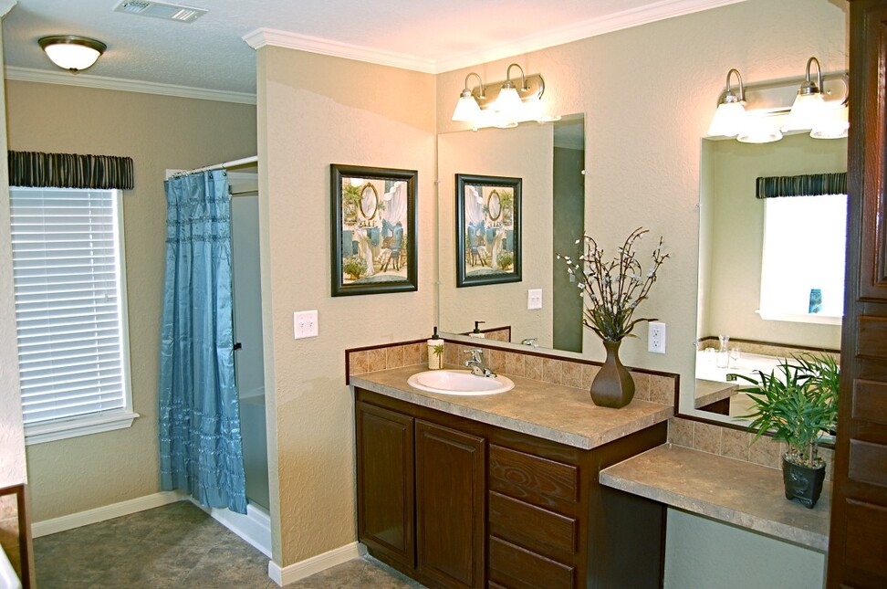 Separate sinks and a sit down vanity in the master bathroom