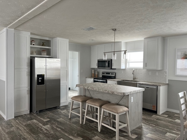 Beautiful Open Concept  Island Kitchen with Stainless Steel Appliances, Farm House Sink with window, and Upgraded Appliances.