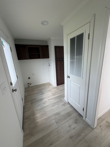 Laundry room with side door. 