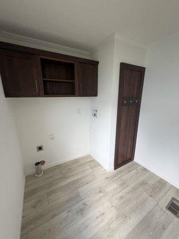 Laundry room with cabinets and coat rack