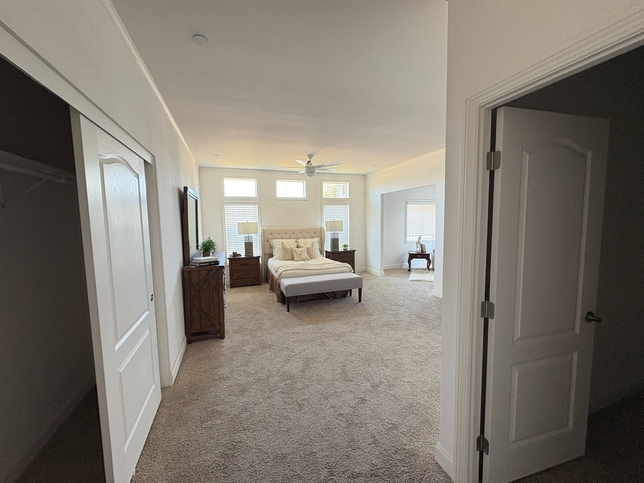 Primary suite with walk in closet and sliding closet