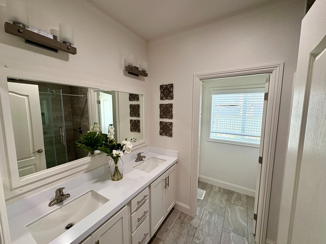 Dual sinks with toilet room and linen closet