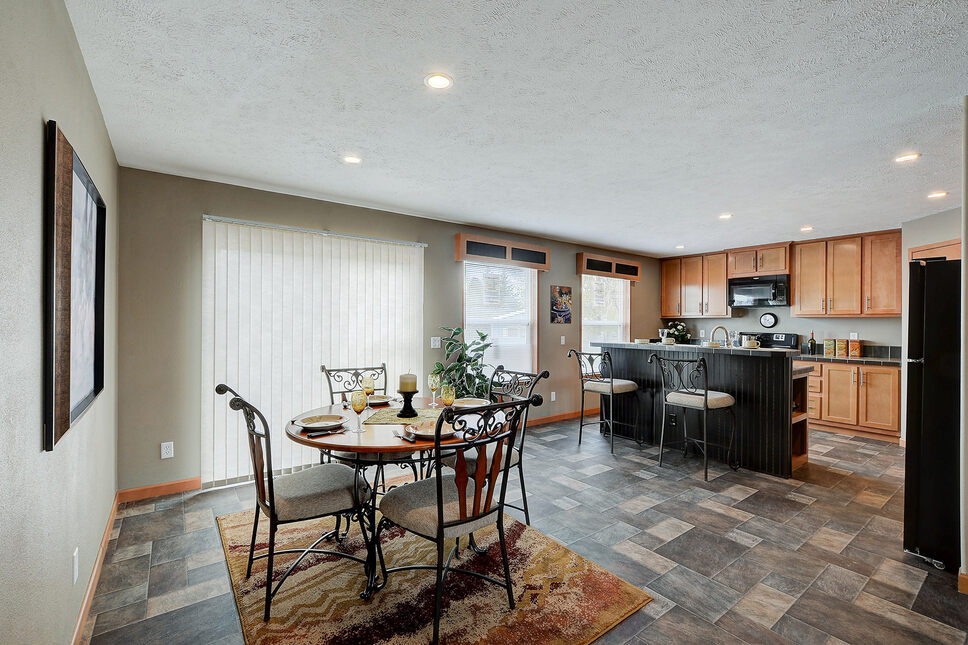 Eat-in bar with dining are in the Danbury 184001 by Friendship Homes