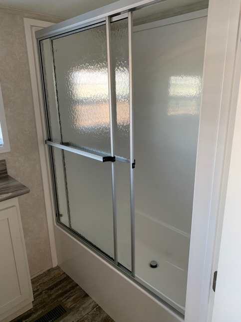 Residential-feel shower in the bath of the 100152 Country Manor from Fairmont Homes.