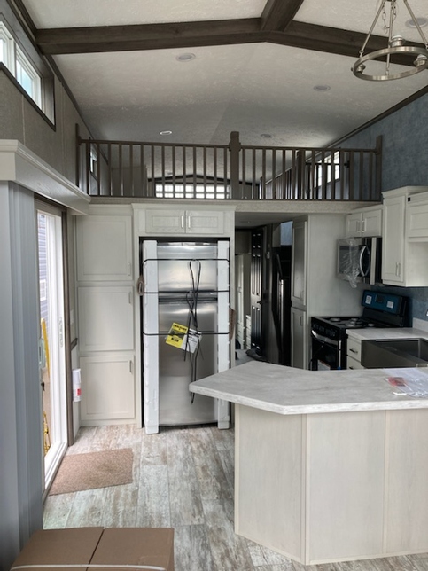 Spaciousness and ceiling beams with open loft in the 100152 Country Manor from Fairmont Homes.