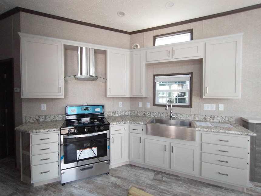 Beautiful white cabinetry and functional use of space in the 190008 Cavco 150 from Fairmont Homes.