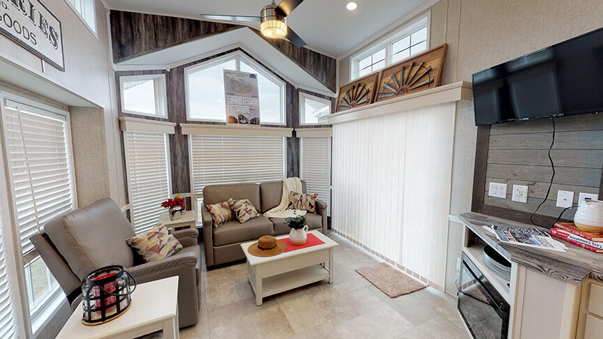 Large living area with plenty of windows in the 100169 Country Manor from Fairmont Homes.
