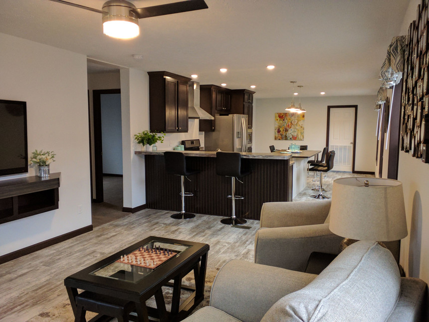Convenient living and dining area with a built in media area in the Inspiration Fulton Model 186035