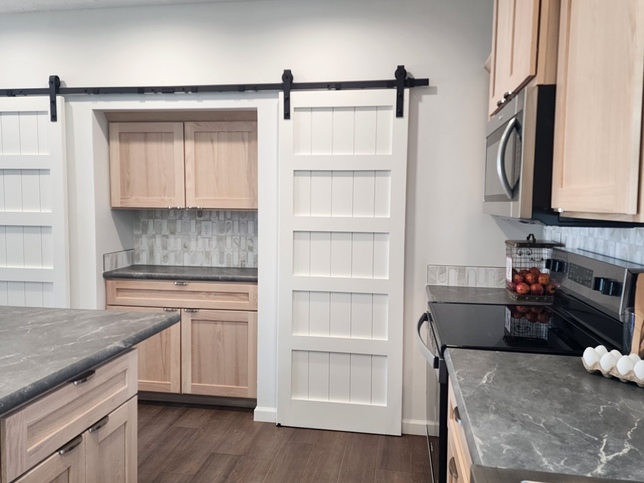 The addition of double barn doors adds character, warmth, and everyday functionality to this thoughtfully designed pantry.

#ABetterWayToBuild