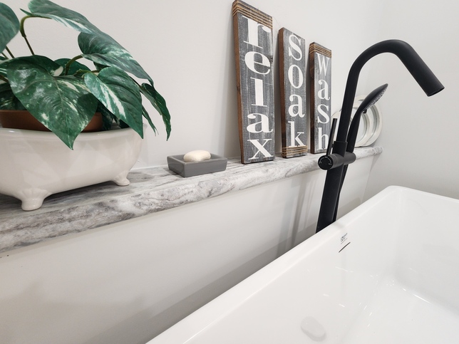 The freestanding soaking tub is beautifully complemented by a matte black floor-mounted tub filler, shower wand and a built-in ledge—perfect for candles, a good book, or your favorite bath essentials.

#ABetterWayToBuild
