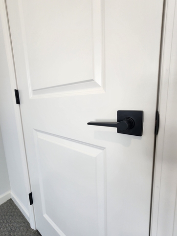 Matte black lever handles and matching hinges deliver a modern, cohesive finish throughout the home.

#ABetterWayToBuild
