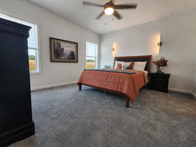 Spacious and beautifully appointed, the owner's suite blends luxurious sculpted carpet with the soft glow of designer-inspired LED sconces, creating a retreat that feels both elegant and effortlessly comfortable. #ABetterWayToBuild
