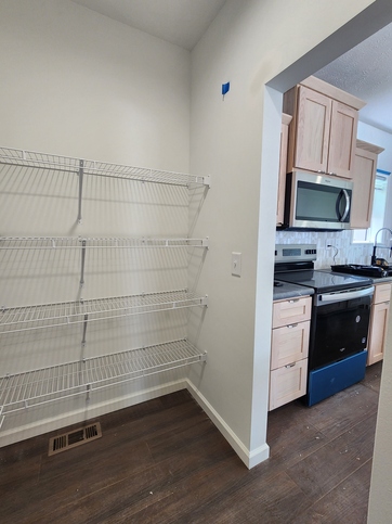 A pantry that works as hard as you do. With four rows of shelving on three walls, it's ready to keep everything organized from day one. Prefer a more custom look? We can add cabinetry to create a pantry that's as beautiful as it is functional!